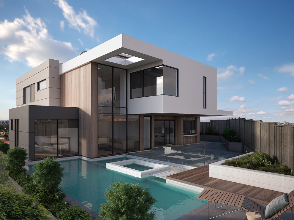 Immagine di una grande piscina monocorsia minimalista personalizzata dietro casa con una vasca idromassaggio e pedane