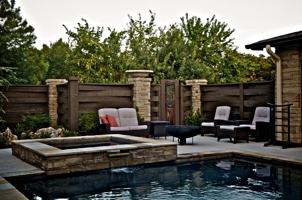 Inspiration for a small world-inspired back rectangular lengths hot tub in Oklahoma City with concrete slabs.