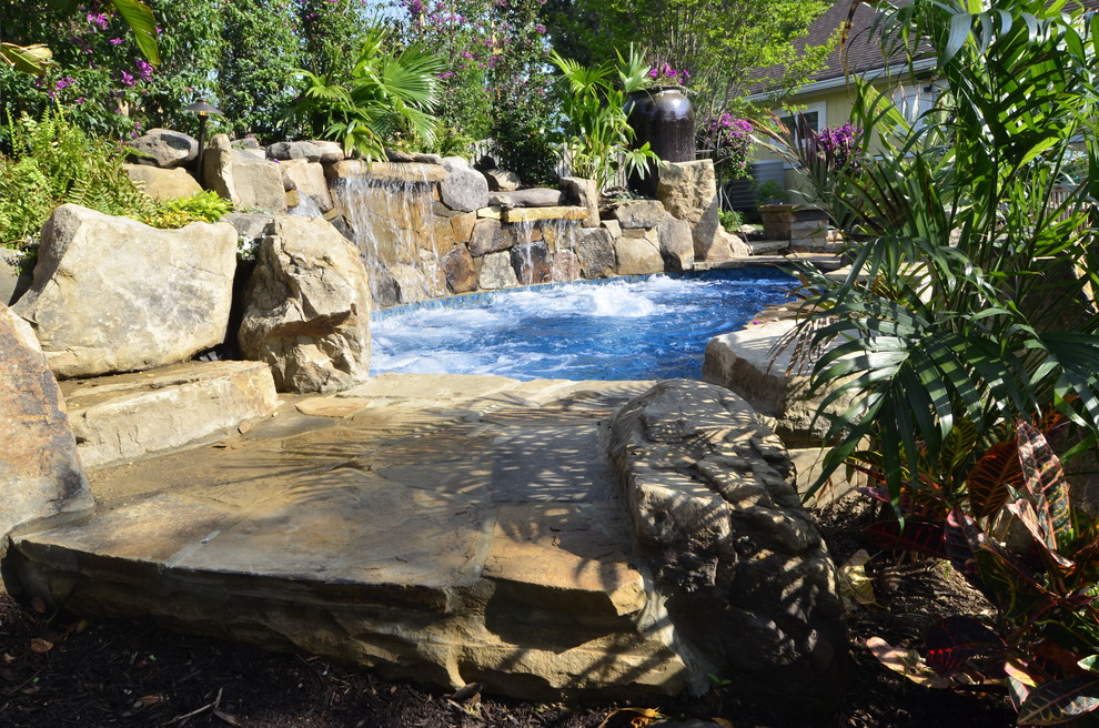 Идея дизайна: большой естественный бассейн произвольной формы на заднем дворе в морском стиле с фонтаном и покрытием из каменной брусчатки