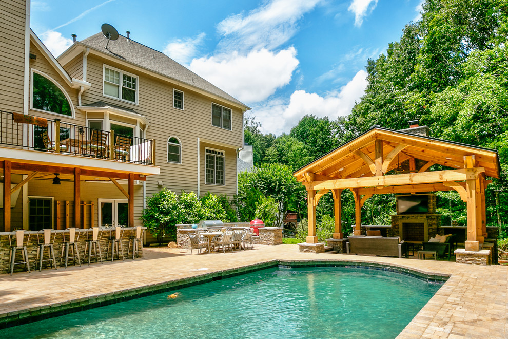 Pool house - huge traditional backyard concrete paver and custom-shaped pool house idea in Charlotte