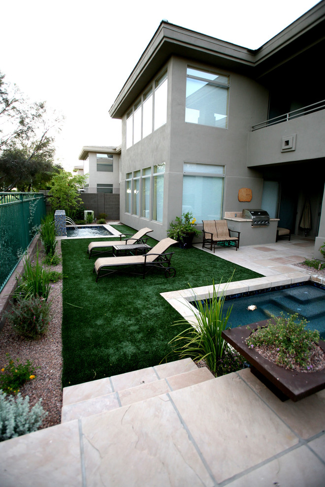 Example of a mid-sized southwest backyard stamped concrete and rectangular pool fountain design in Phoenix