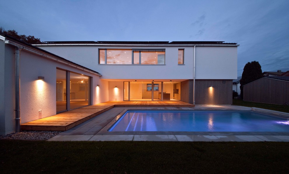 Idee per una piscina minimal rettangolare di medie dimensioni con pavimentazioni in cemento
