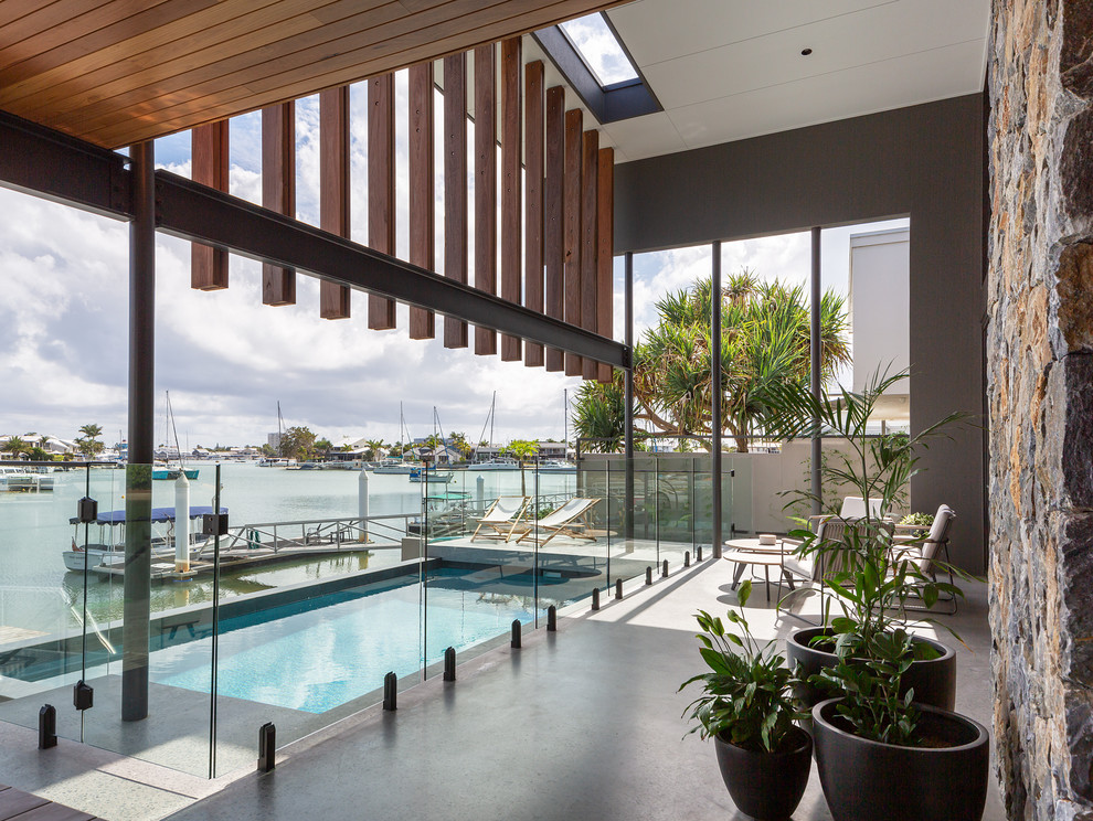 Trendy concrete and rectangular lap pool photo in Sunshine Coast