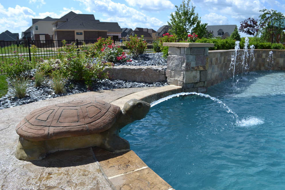 Photo of a large contemporary back custom shaped swimming pool in Detroit with a water feature.