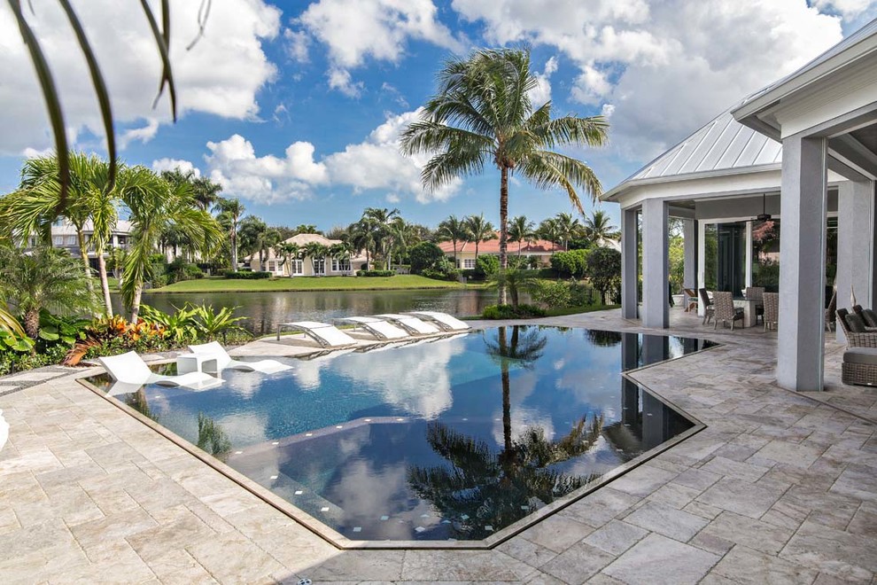 Mid-sized trendy backyard concrete paver and custom-shaped lap hot tub photo in Miami
