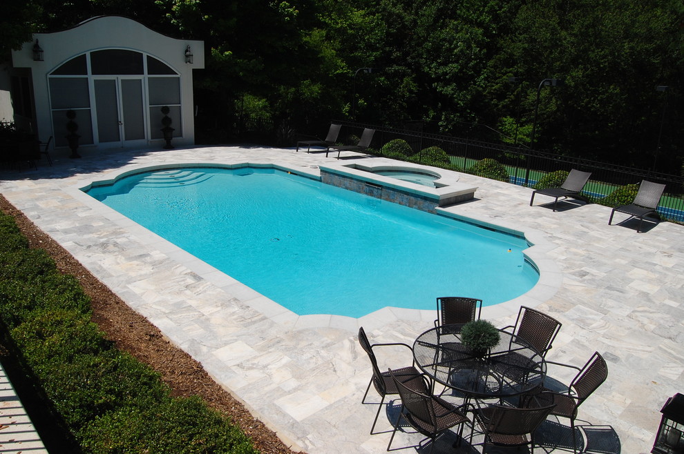 Example of a mid-sized classic courtyard stone and rectangular natural hot tub design in Charlotte