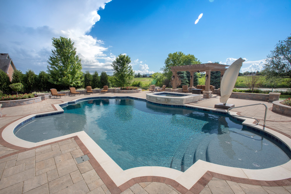 Photo of a medium sized mediterranean back custom shaped lengths hot tub in Chicago with concrete paving.
