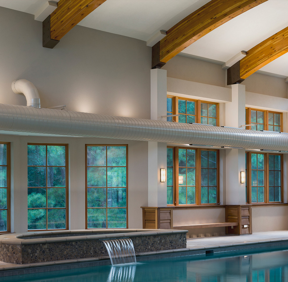 Expansive traditional indoor rectangular swimming pool in Baltimore with a water feature.