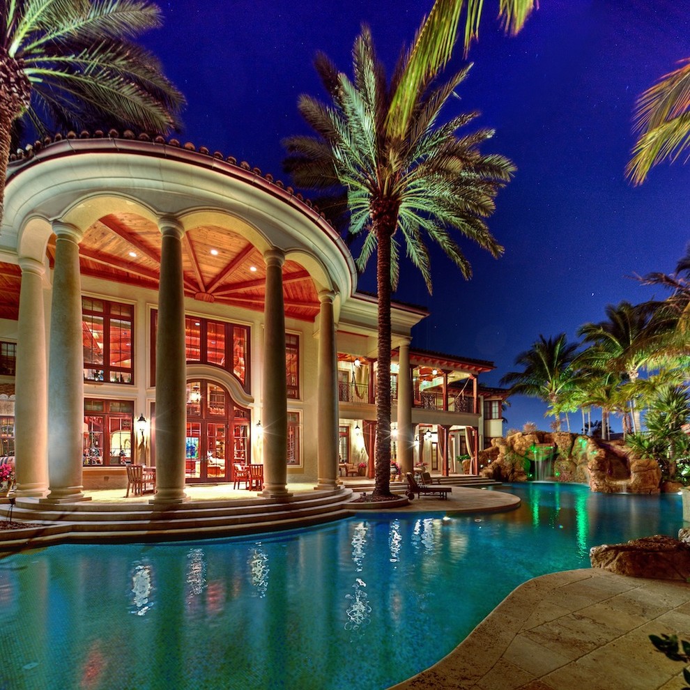 This is an example of an expansive mediterranean back custom shaped natural swimming pool in Miami.