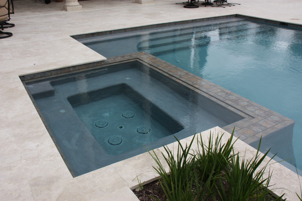 Mid-sized trendy backyard concrete paver and rectangular infinity hot tub photo in New Orleans