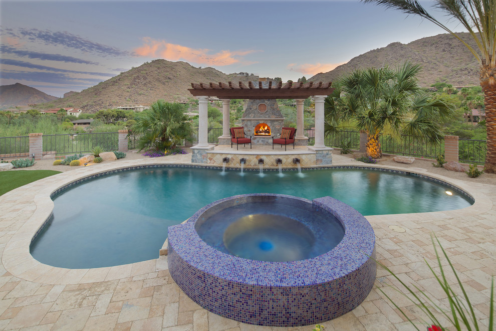 Пример оригинального дизайна: большой естественный бассейн произвольной формы на заднем дворе в средиземноморском стиле с джакузи и мощением тротуарной плиткой