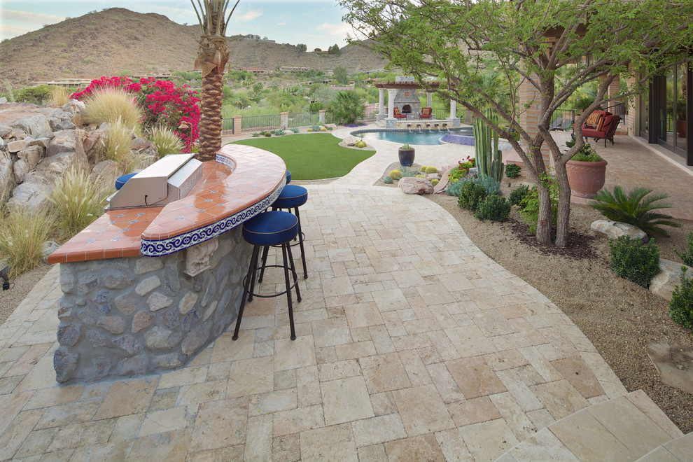 Example of a large tuscan backyard concrete paver and custom-shaped natural hot tub design in Phoenix