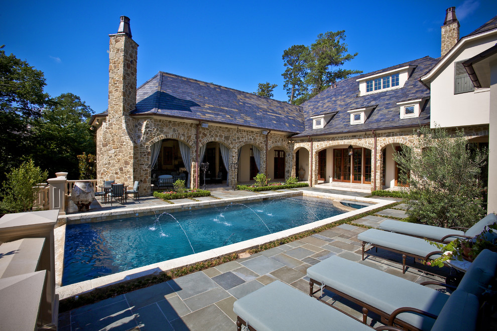 Inspiration for a large mediterranean courtyard rectangular lengths swimming pool in Houston with tiled flooring.