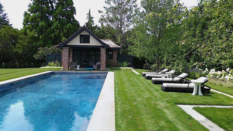 Ejemplo de casa de la piscina y piscina natural actual grande a medida en patio trasero con adoquines de piedra natural
