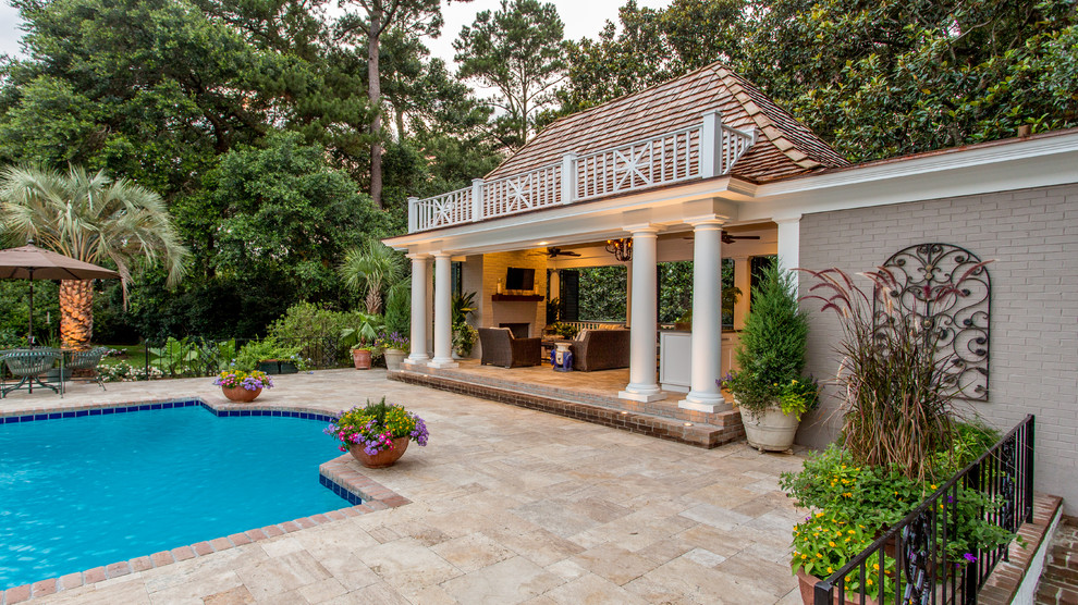 This is an example of a traditional back swimming pool in Other with a pool house.