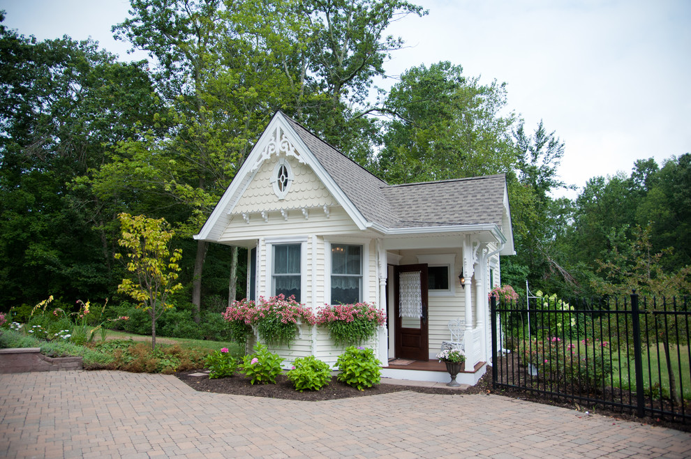 Medium sized victorian back rectangular lengths swimming pool in Bridgeport with a pool house and natural stone paving.