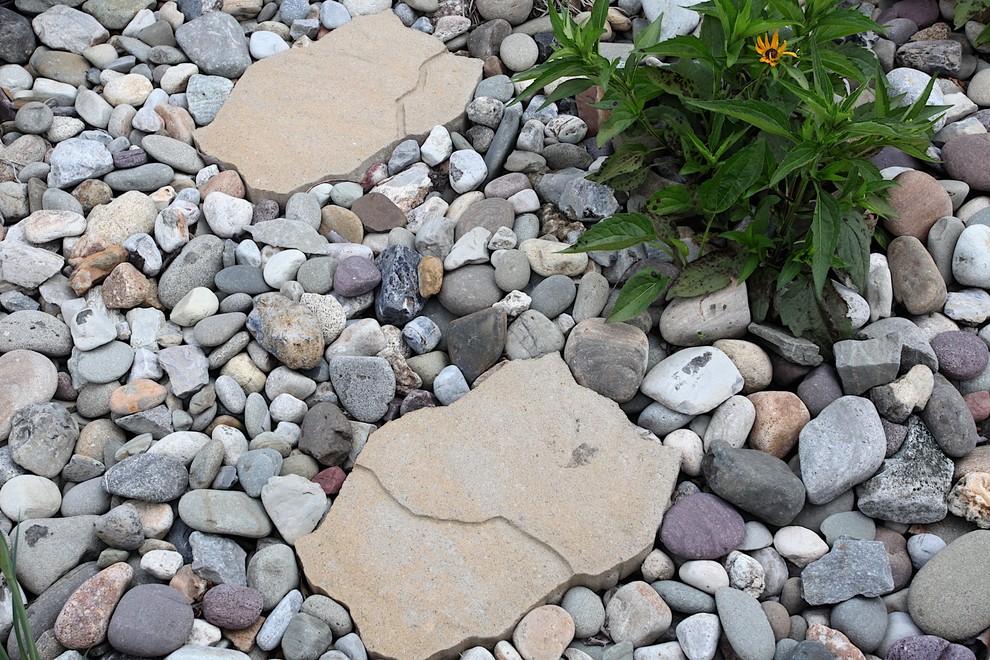 This is an example of a mid-sized traditional backyard concrete paver water fountain landscape in New York.