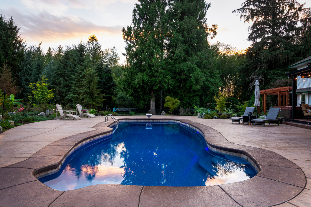 Pool - large traditional backyard stamped concrete and custom-shaped natural pool idea in Vancouver