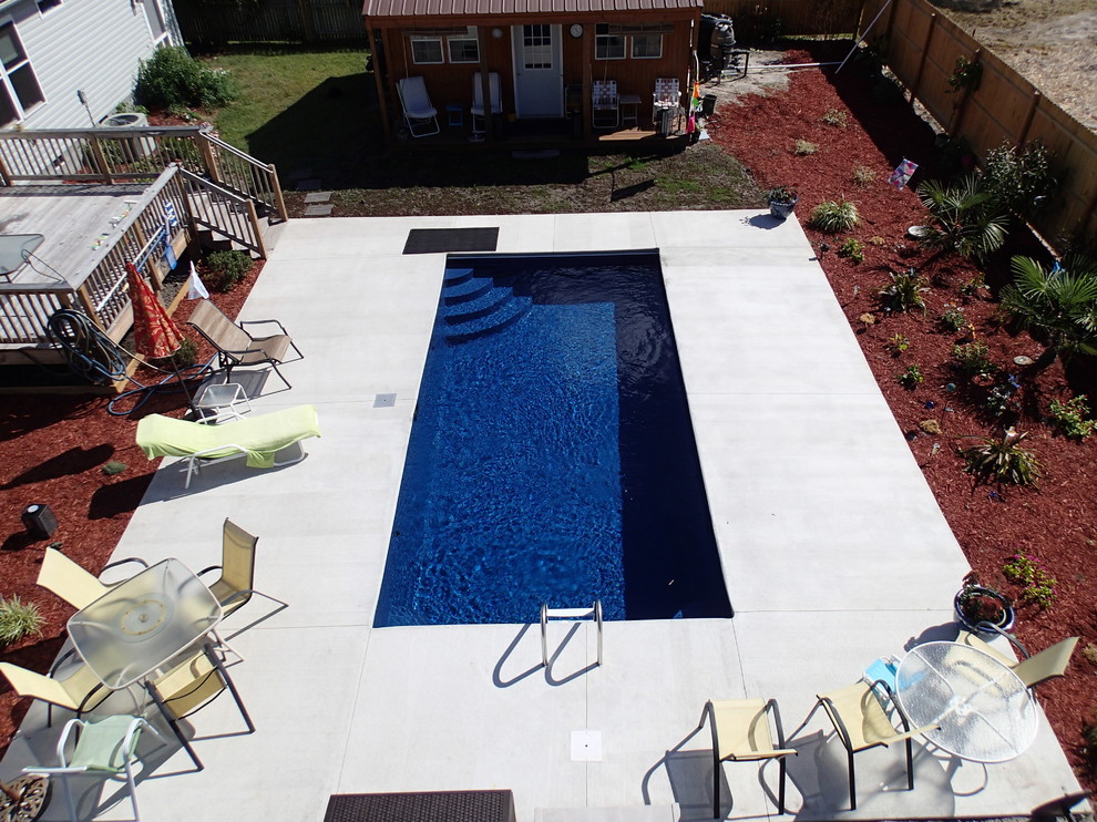 Ejemplo de piscina tradicional de tamaño medio rectangular en patio trasero