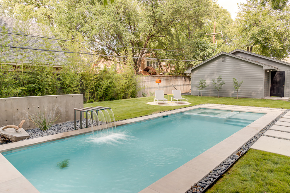 Example of a mid-sized trendy backyard concrete paver and rectangular pool design in Dallas