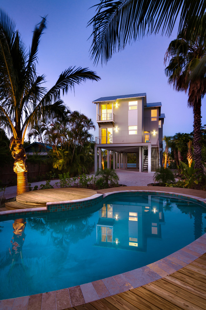 Cette photo montre une petite piscine avant bord de mer en forme de haricot avec une terrasse en bois.