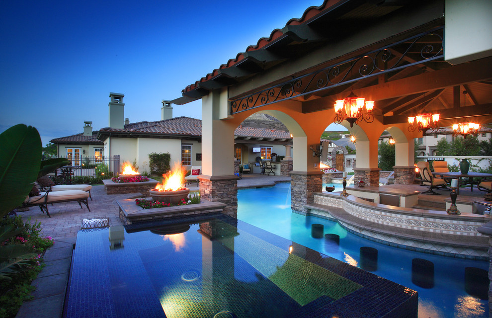 Pool - large mediterranean backyard stone and custom-shaped lap pool idea in Los Angeles