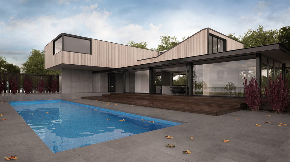Diseño de piscina alargada minimalista grande rectangular en patio trasero con suelo de baldosas