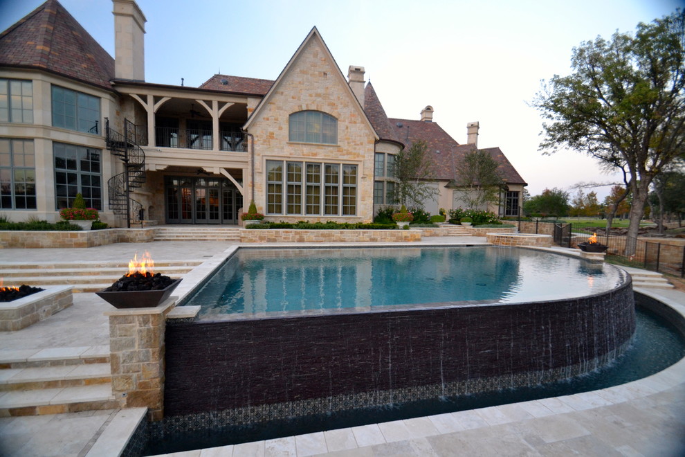 Pool fountain - huge transitional backyard stone and custom-shaped infinity pool fountain idea in Dallas