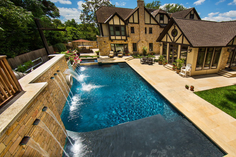 Design ideas for a large country side rectangular lengths swimming pool in Austin with a water slide and natural stone paving.
