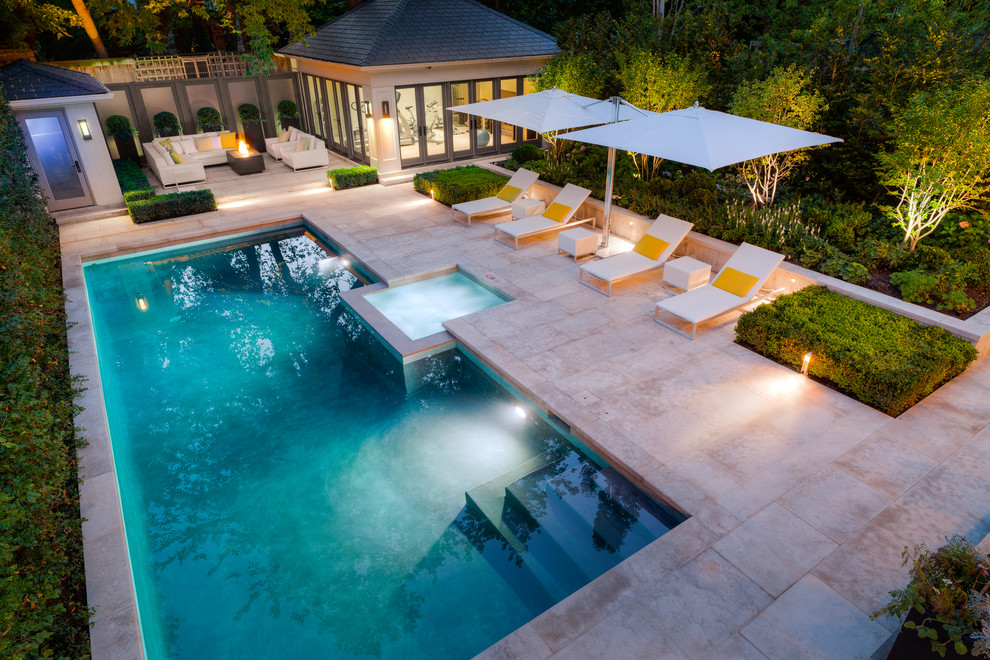 Photo of a medium sized traditional back rectangular swimming pool in Other with natural stone paving.