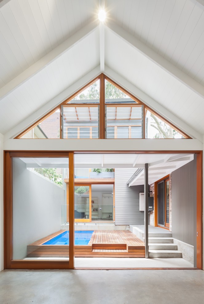 Inspiration for a medium sized scandi courtyard lengths swimming pool in Sydney with decking.