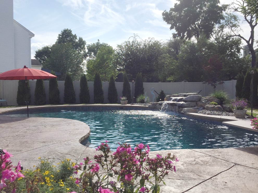 Forks Township custom pool with sunshelf & rock waterfall Traditional