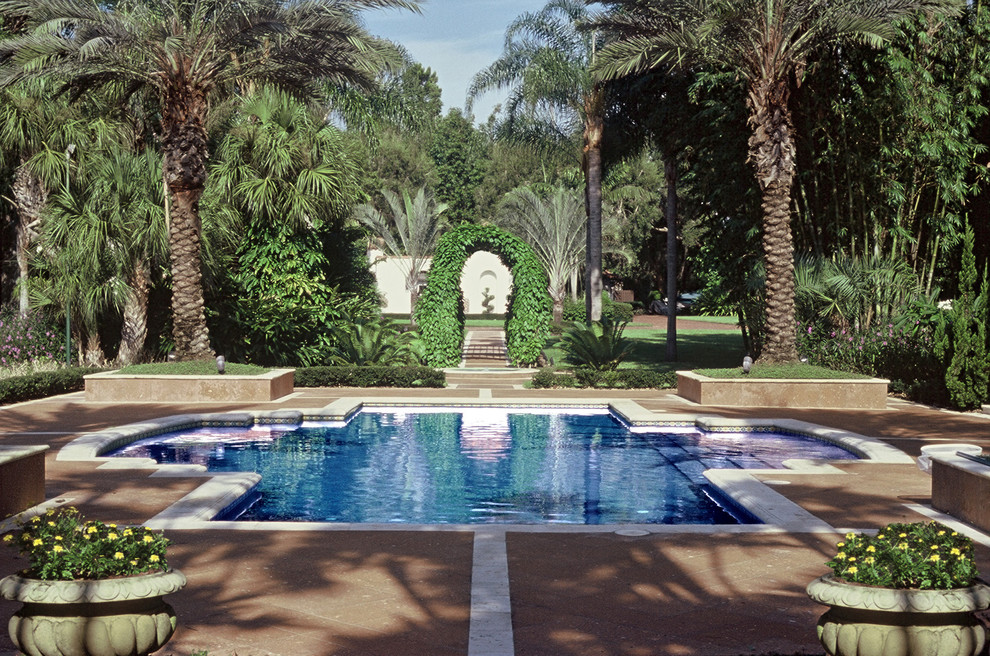 This is an example of a mediterranean swimming pool in Orlando with brick paving.