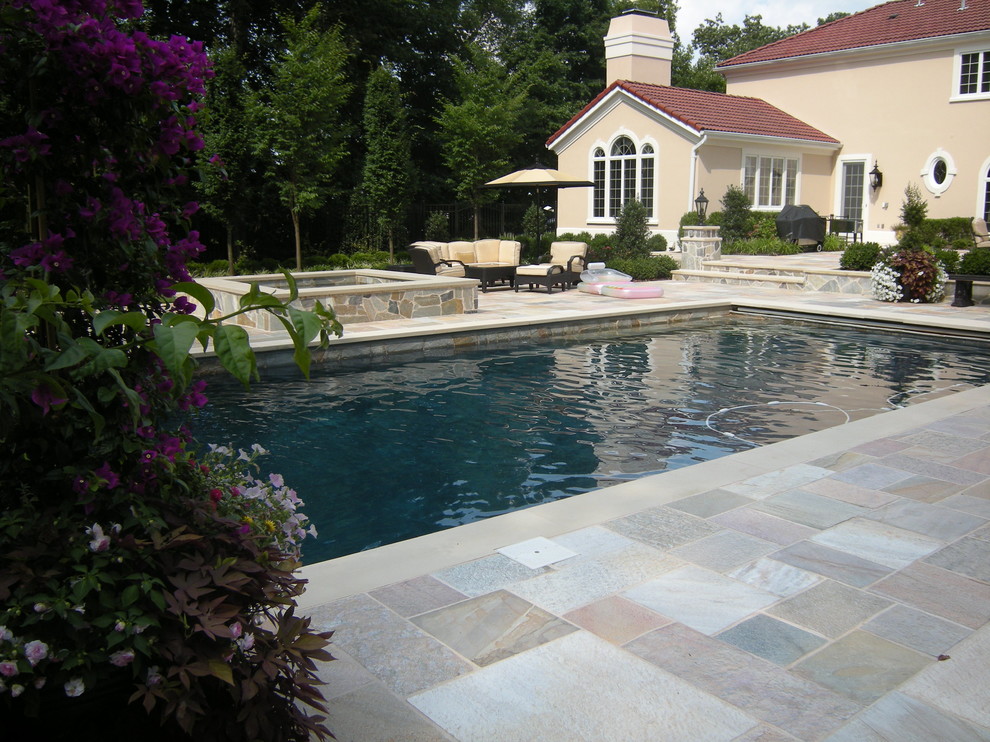 Inspiration for a mid-sized contemporary backyard stone and rectangular lap hot tub remodel in New York
