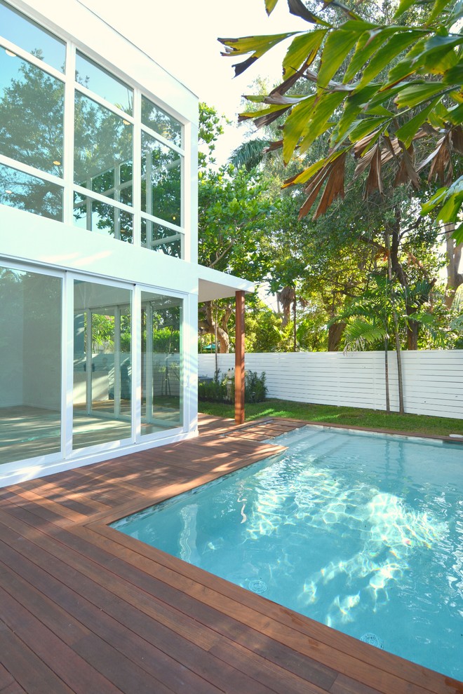 Inspiration for a large modern backyard custom-shaped pool remodel in Miami