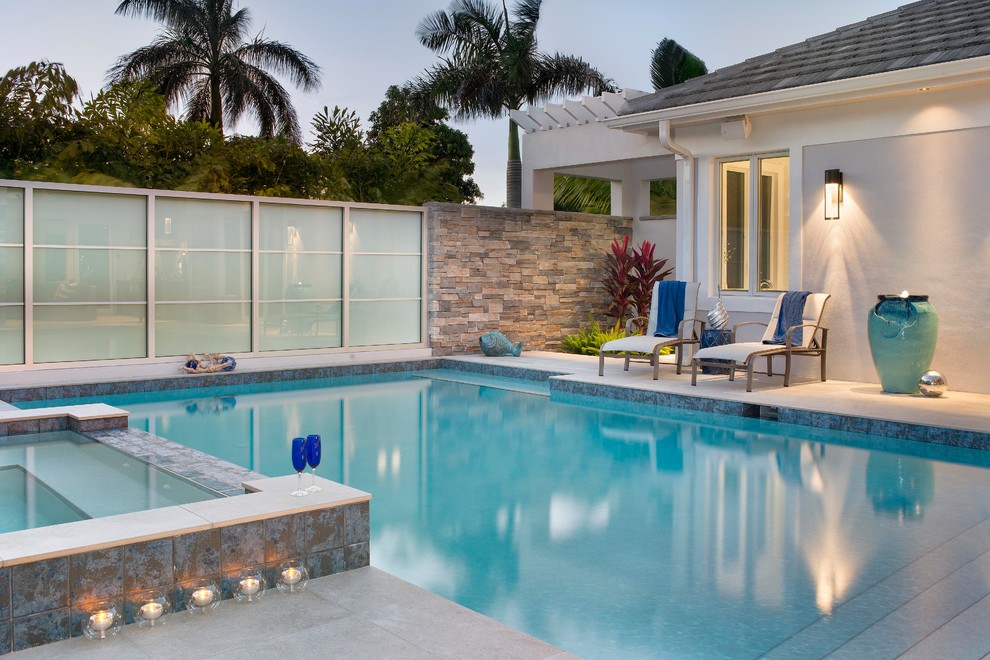 Inspiration for a large transitional courtyard rectangular and stone natural hot tub remodel in Miami