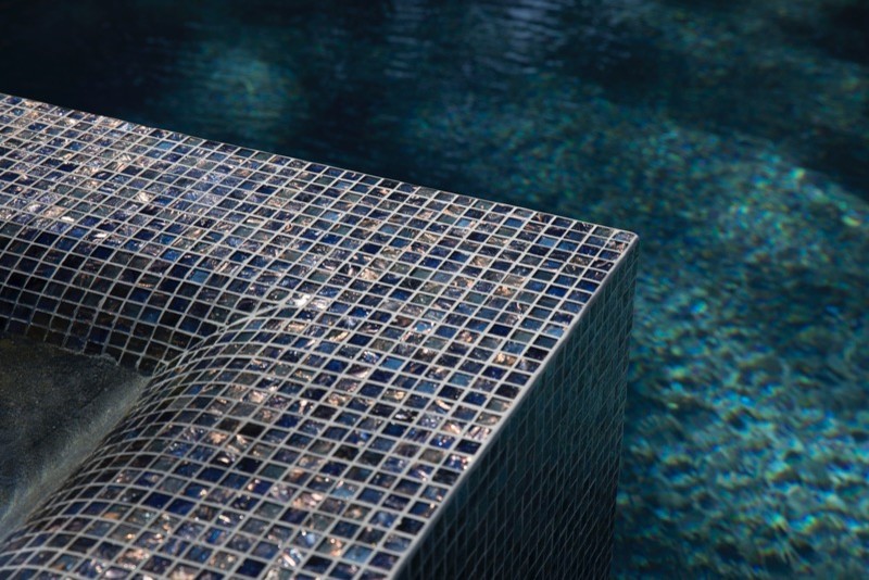 Inspiration for a large contemporary back rectangular natural hot tub in New York with natural stone paving.