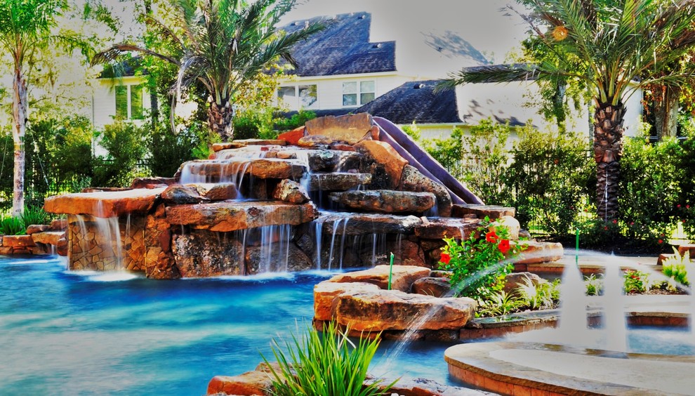 Esempio di una grande piscina minimalista personalizzata dietro casa con fontane e cemento stampato