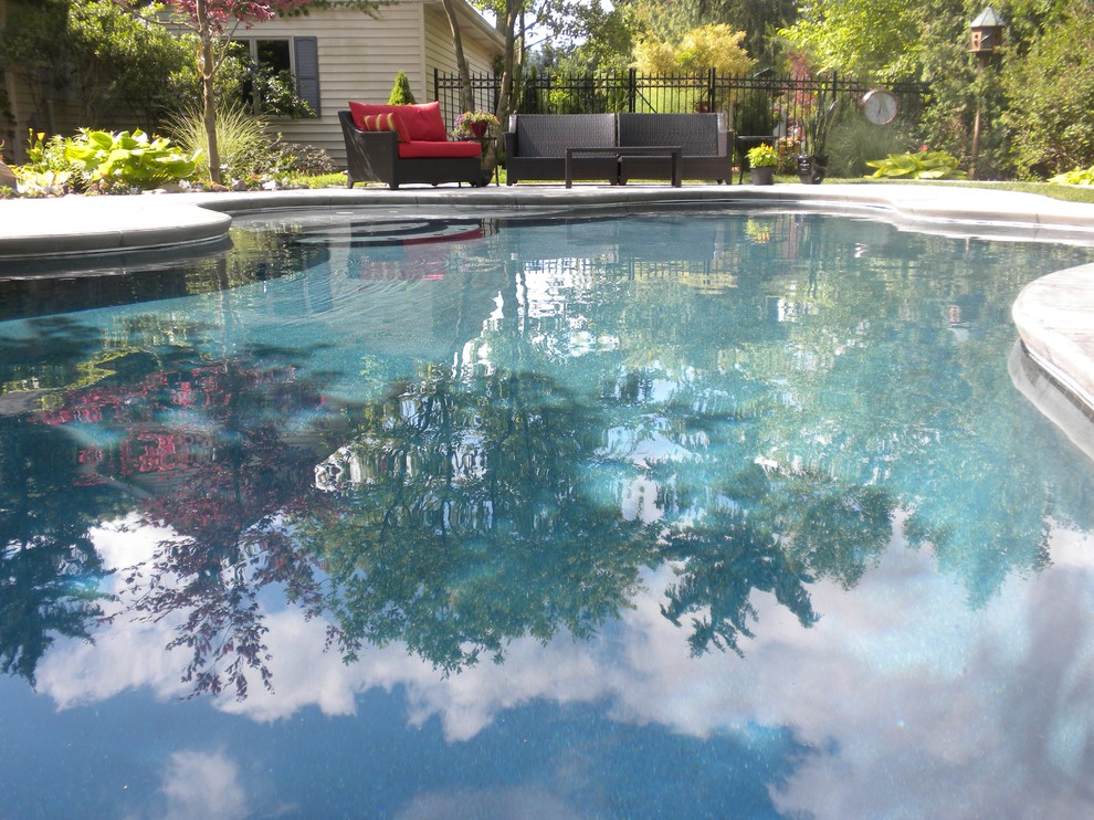 Mittelgroßer Klassischer Pool hinter dem Haus in individueller Form mit Stempelbeton in Sonstige