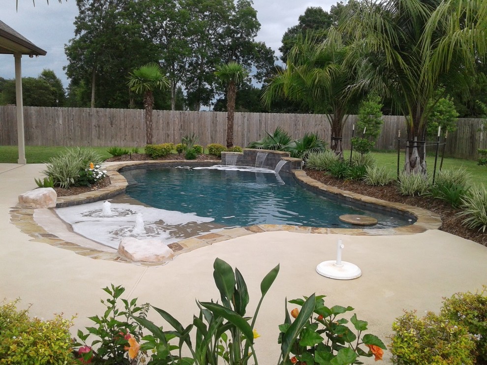 Freeform, natural pool with beach entry, tanning ledge,raised wall