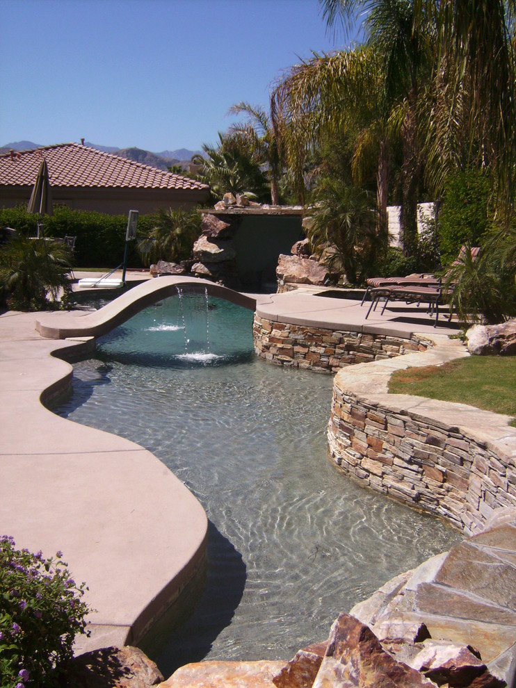 Pool fountain - large tropical backyard concrete and custom-shaped lap pool fountain idea in Other