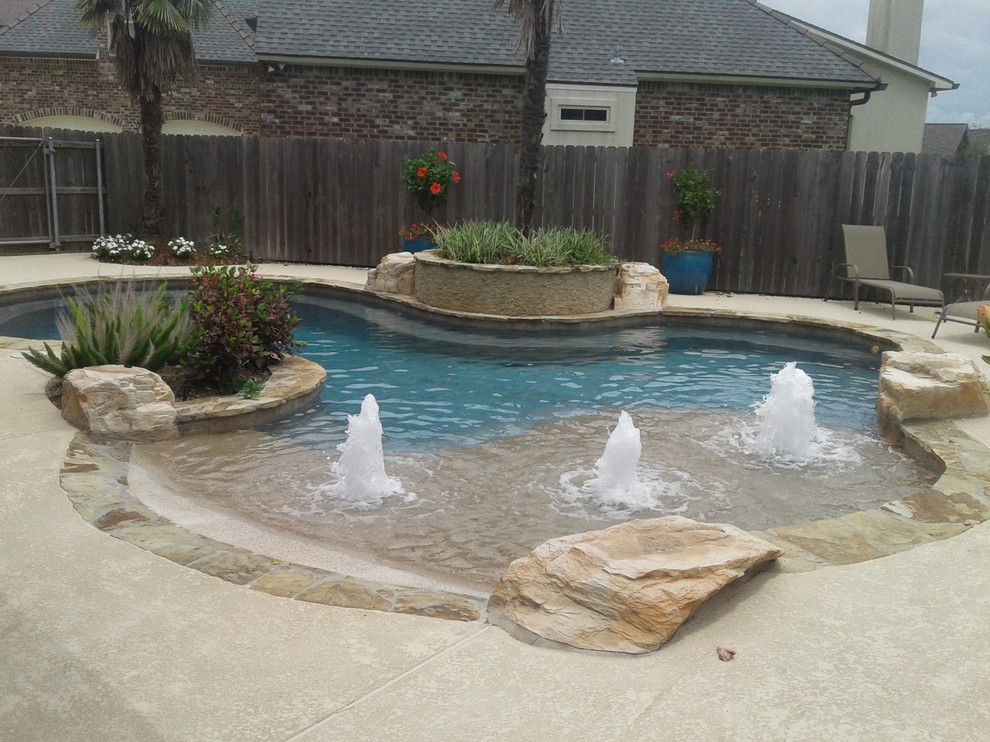 Freeform pool, flagstone coping, beach entry, rico rock boulders