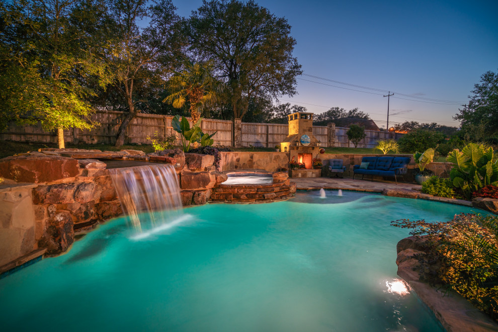 Photo of a large world-inspired back custom shaped natural swimming pool in Other with decking.