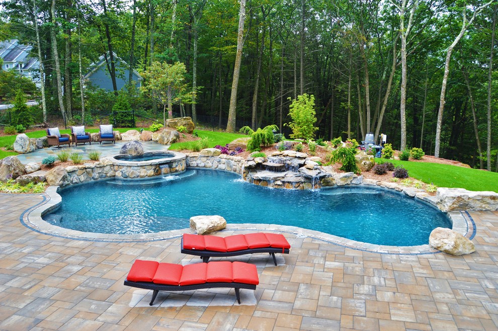 Large elegant backyard concrete paver and custom-shaped natural hot tub photo in Bridgeport
