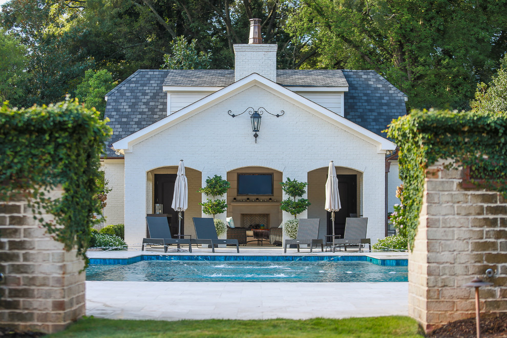 Design ideas for a mediterranean swimming pool in Charlotte with a pool house.