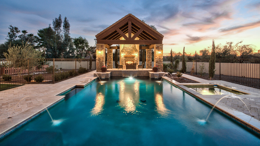Idée de décoration pour une piscine arrière champêtre rectangle avec un bain bouillonnant et des pavés en béton.