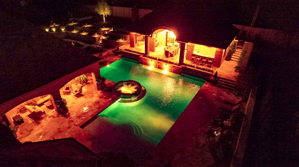 Mid-sized elegant backyard stone and l-shaped lap pool house photo in Oklahoma City