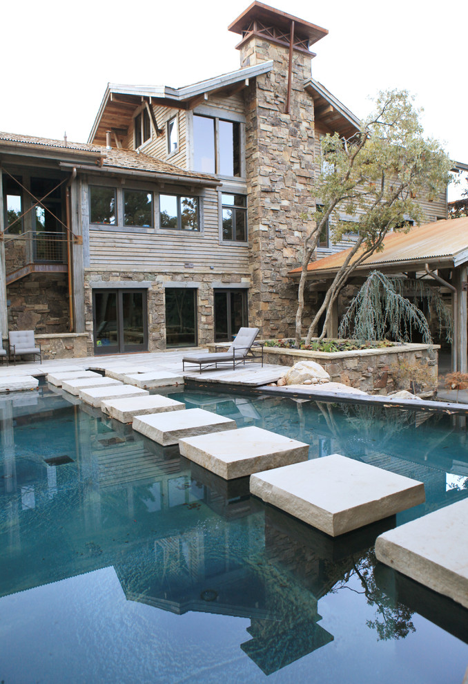 Inspiration for a rustic lengths swimming pool in Salt Lake City with concrete paving.