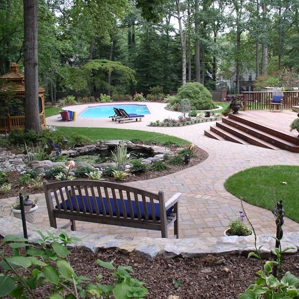 Design ideas for a large traditional back rectangular lengths swimming pool in Baltimore with brick paving.