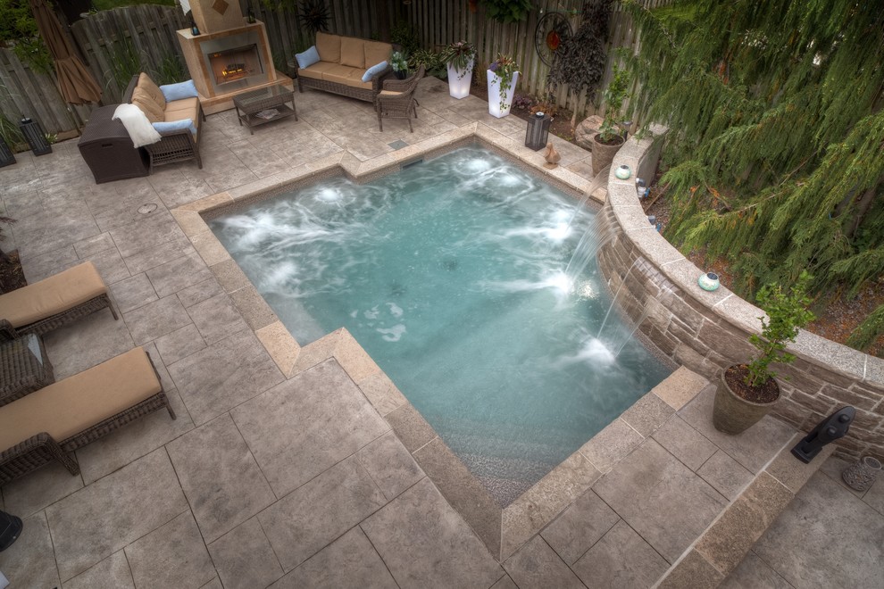 Example of a small trendy backyard stamped concrete and custom-shaped hot tub design in Toronto